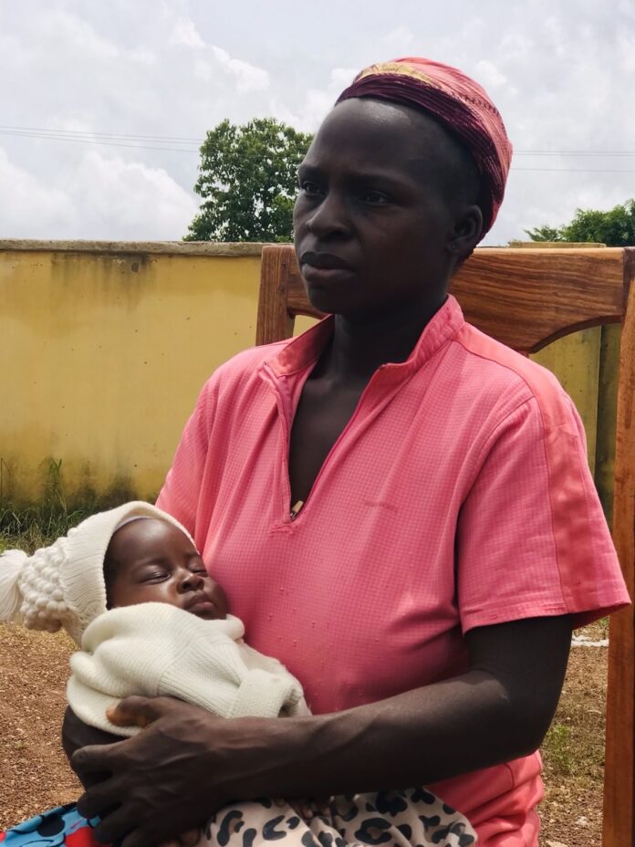 Nigerian Resilience: Eunice Simon of Mangu County, Plateau State, Nigeria was shot in the leg and chest in the 9th month of pregnancy on May 16, 2023. She had trauma-induced labor as a result and gave birth three hours later, while being treated for bullet wounds at a small hospital in Mangu. Photo by Masara Kim.