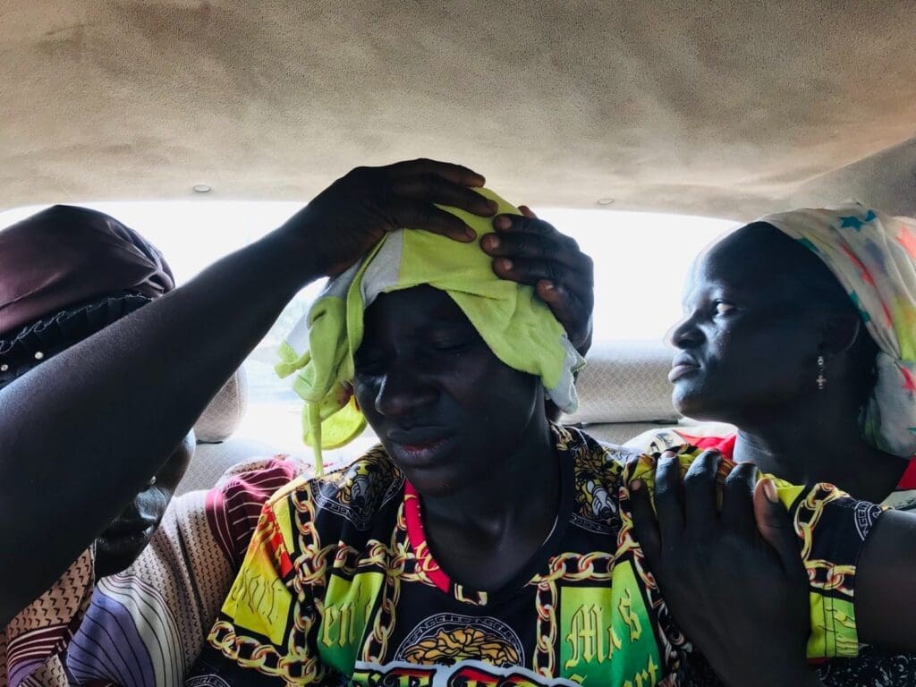 Protestor with head bandage is conveyed by van to a local hospital Monday morning, Aug. 7. Photo by Masara Kim.