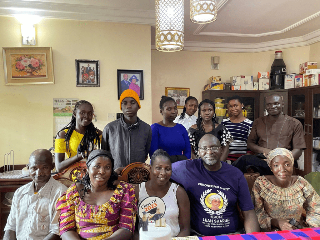 Friends and family surround Sarah Emanuel, in white top, and Emmanuel Ogebe, blue t-shirt, in Abuja. Photo by Emmanuel Ogebe.