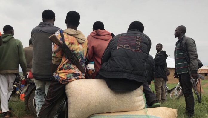 A band of citizen guards awaits news of a security threat June 18 in Plateau State, which neighbors Kaduna State. credit Masara Kim.
