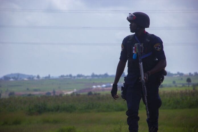 Policeman looking over an attacked village in Mangu on 1 September.