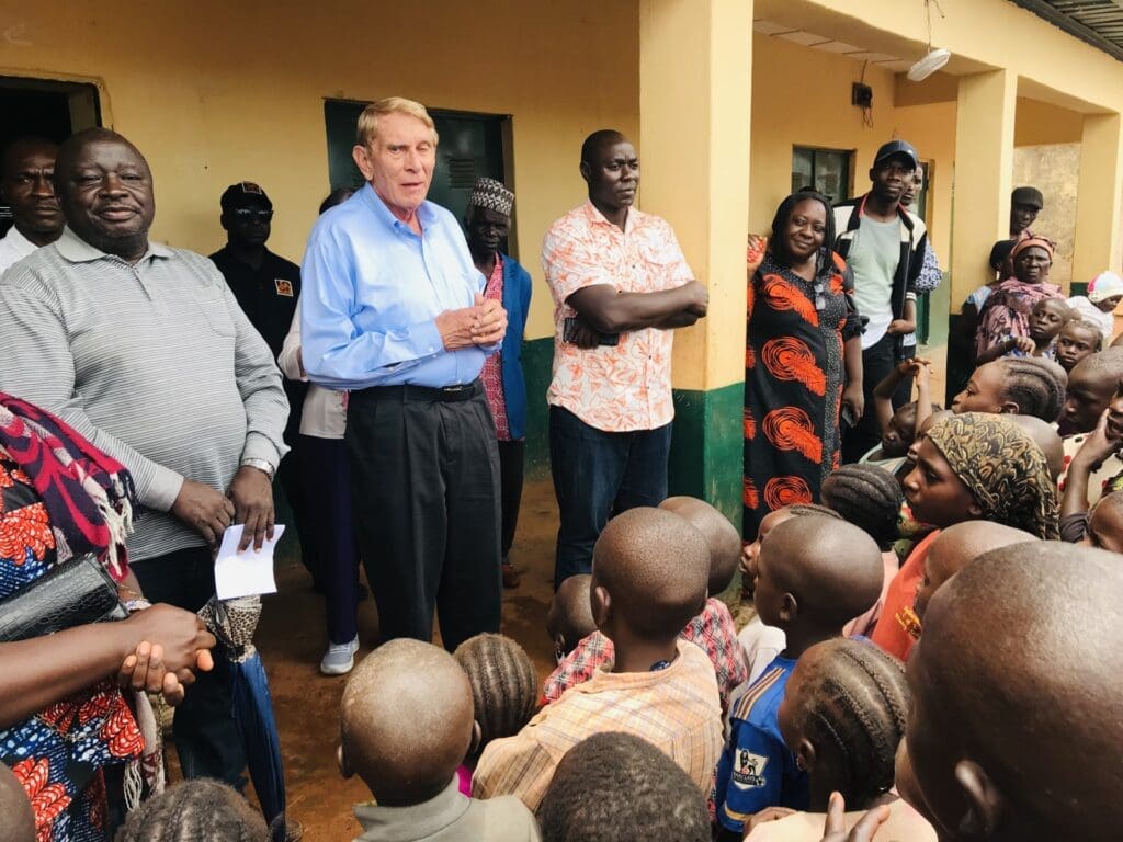 Rev. William Murray comforts displaced men, women and children in Mangu on Sept. 1, 2023. Murray discounts the term “Farmer herder” clash as adequate label for mass killings in Plateau which are not reciprocal events. Photo by Masara Kim.