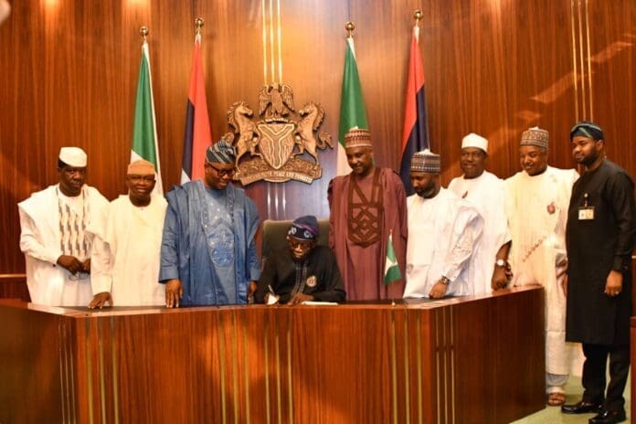President Bola Tinubu flagged by Senators and top government officials at the signing of the 2023 supplementary budget. Credit: President Bola Ahmed Tinubu Media Centre on X.
