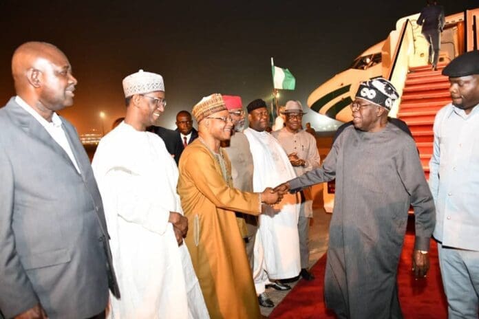 President Bola Tinubu being welcomed on his arrival by government officials at the presidential wing of the Nnamdi Azikwe Airport in Abuja. Photo credit: X/@LeadershipNGA.