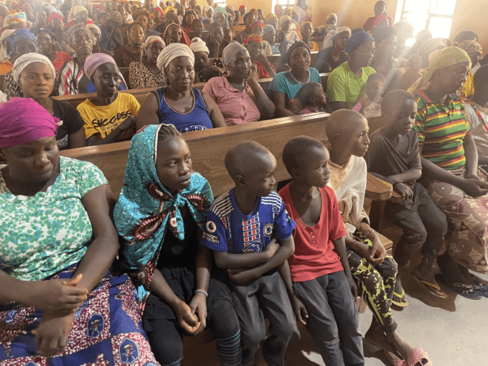 Women and children of Bokkos town, Nigeria, hearing reports that the Nigerian army wants to build a base in their community. Photos by Stephen Kefason.