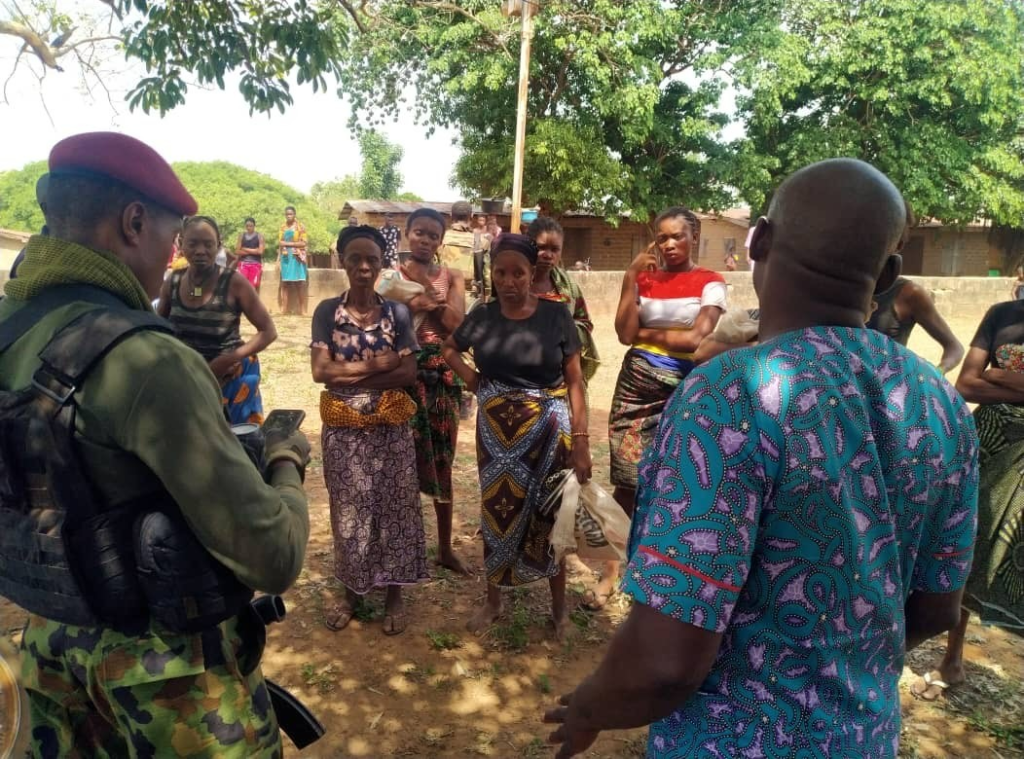 A soldier speaks to traumatized women in Ugbobi, after they narrowly escaped the March 26 attack. Photo credit, Zariyi Yusuf  