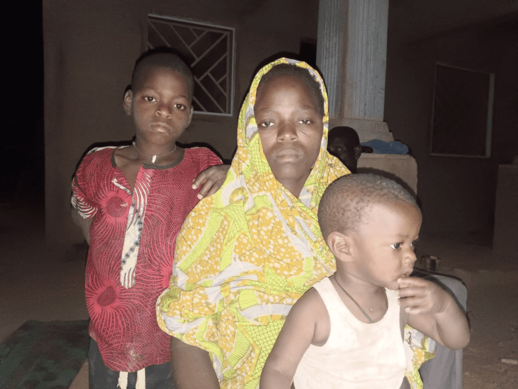 Grieving: Family of slain civilian guard, Thomas Illiya. Mrs. Thomas Illiya seen the day after the attack with her eldest son, Luis, 8, and Wisdom, 18 months. photo by TruthNigeria Staff.  
