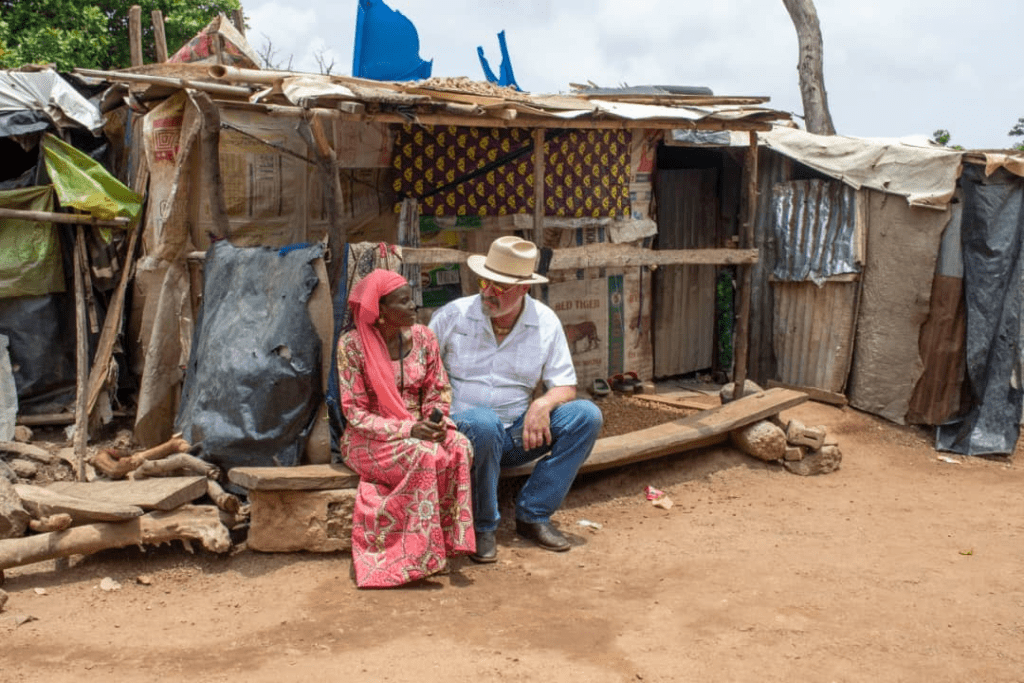 Left: Ms Hanatu Ango, an Internally displaced person from Gwoza, and Mike Arnold, NGO founder, right. Ms. Hanatu and her three daughters ended up here in 2014 along with hundreds of other IDPs and have been stuck here ever since, Arnold tells TruthNigeria. Ms. Hanatu built the shanty herself and teaches school at the camp.