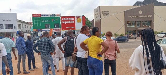 Stranded traders outside Banex plaza after soldiers restricted access on Monday. Photo credit: X/@TrustRadioLive.