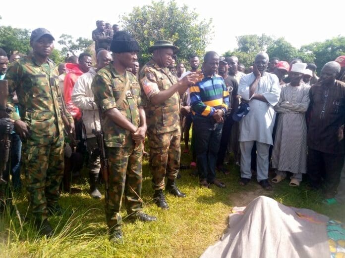 Nigerian Army Major Mohammed Abdullahi gestures to Kpara mourners, promising that the Nigerian will 