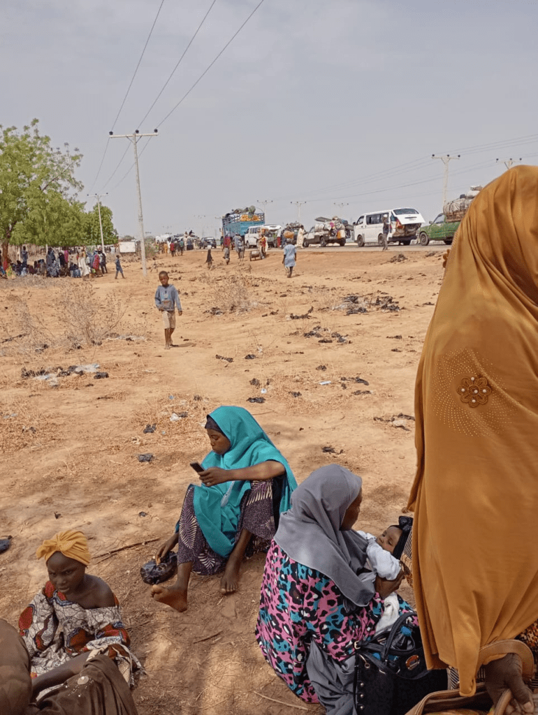 Highway scene through Sambisa Forest in Borneo, showing slow-moving traffic preceded by mine sweepers clearing bombs planted by ISWAP and Boko Haram.  Credit Mike James. 