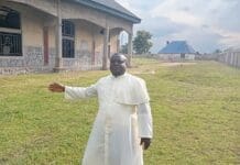 Rev. Father Jacob Ankauu stands at his abandoned church in besieged Ayati, in Ukum County, Benue State. Credit: Mike Odeh James.