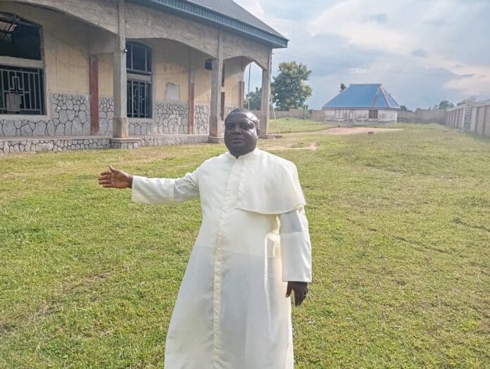 Rev. Father Jacob Ankauu stands at his abandoned church in besieged Ayati, in Ukum County, Benue State. Credit: Mike Odeh James.