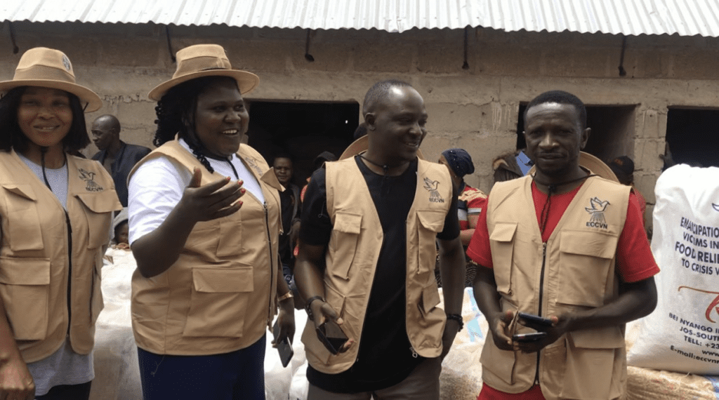 Solomon Dalyop (right), a leading human rights advocate in Jos, leads volunteers of Emancipation Center for Crisis Victims in Nigeria during a distribution of grains donated by CSI in Bokkos on August 3. Credit: Masara Kim.