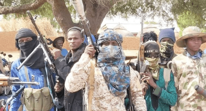 Bandit Kingpin Bello Turji (center behind mask) pictured with his lieutenants in a Zamfara town. Credit: Bello Turji.