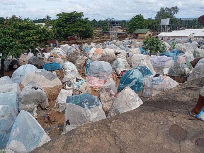 Makurdi IDP camp shows families sheltering under mosquito net shelters. Credit: Mike Odeh James.