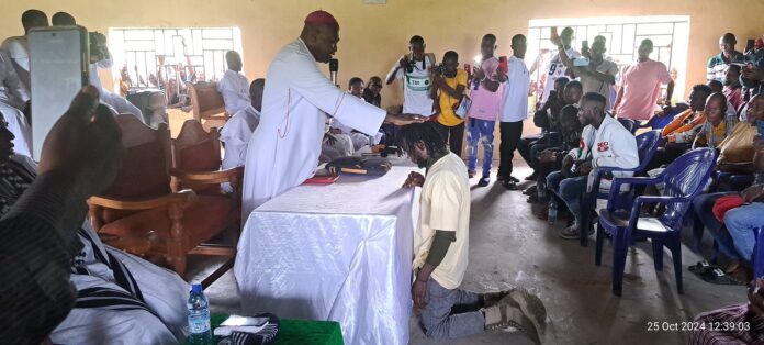 25 October, gang leader Chen kneels before Bishop Dugu in Gbagir, Nigeria