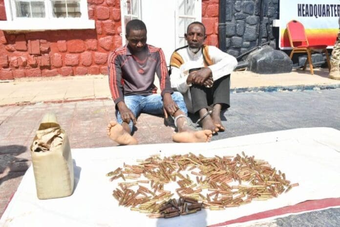 Mohammed Musa, alias Mamman, and Mallam Alhassan Samaila with seized 439 rounds of 7.62mm ammunition. Photo credit: Punch.