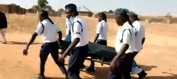 Bodies of Enock and Josiah Pudzu carried by Boys Brigade at funeral. Courtesy of Pastor Maina Yahi.