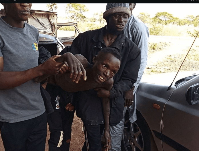 Mr. Jibril Zephaniah, weakened by 90 days of starvation, assisted by Simon Nuhu to board a rescue vehicle on Feb. 23, 2025. credit: Mike Odeh James.