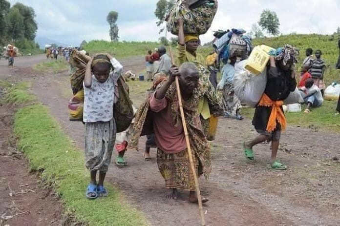 Residents trudging out of Gbagir on foot. Credit Ekani Olikita.