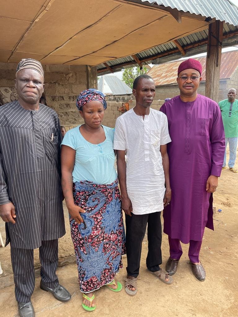 Faces of devastation: at left and far right are Evangelical Church Winning All clergy consoling the mother and father of Deborah two weeks after her burial.  Mr Emmanuel Garba was asked if he would sue the authorities. "No," he replied. "We leave everything to God."