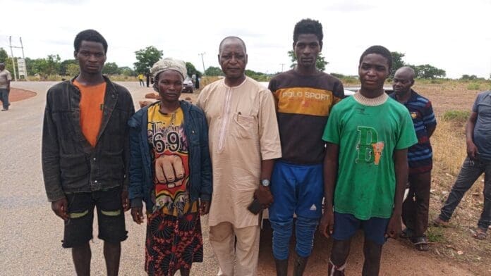 TruthNigeria reporter Luka Binniyat, center, stands with survivors of 49 days of torture in forest in Kachia, approximately 20 miles south of Kaduna City. credit: Mike Odeh James.