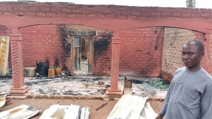 Burned and damaged building in Yelewata showed off by local leaders. Photo by Truth Nigeria Staff.
