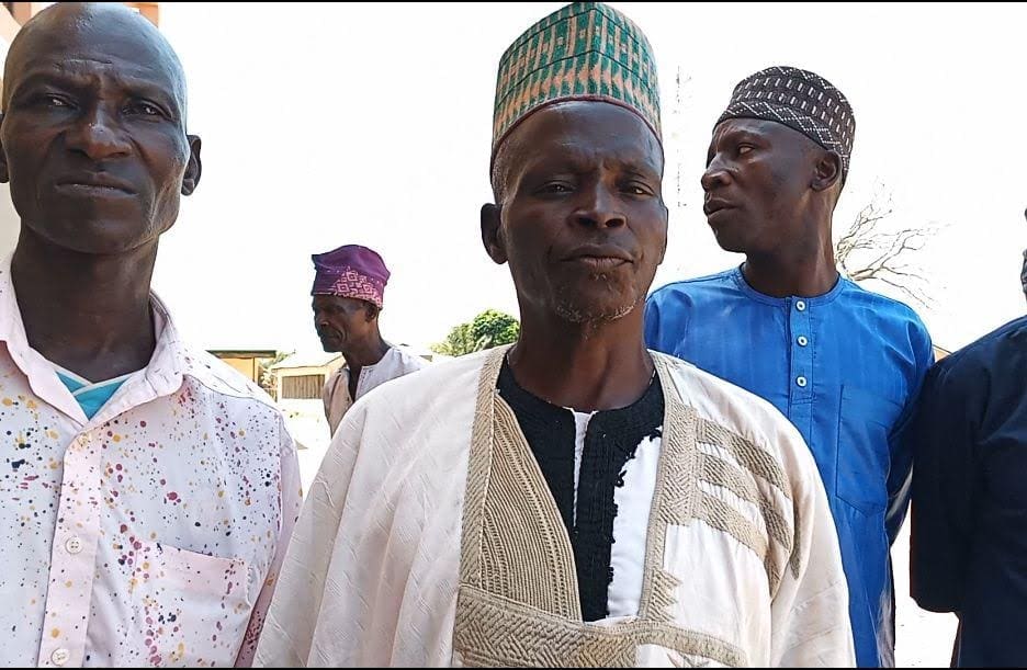 Traditional Ruler of Libere with the Cap The secretary of Libere in white shirt. Photo by Mike Odeh James.