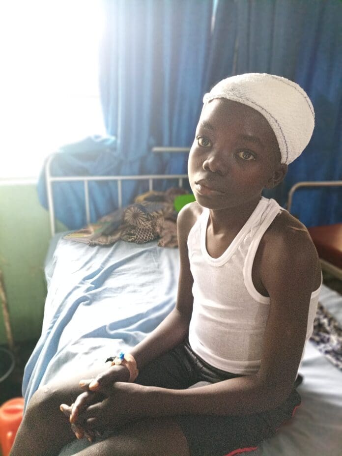 Matthew Sunday, 16 years old survived gunshot wounds. He couldn't talk to TruthNigeria reporter. Photo Credit Lawrence Zongo, TruthNigeria.