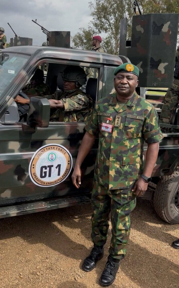 CDS Christopher Musa poses beside a truck branded in the new name and Logo of the special task force in Plateau State. Credit Golok Namwa. 