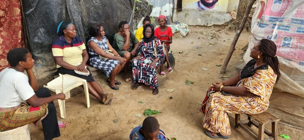 Duile speaking with women during an outreach visit to an IDP camp. Photo credit: cafcares.org.