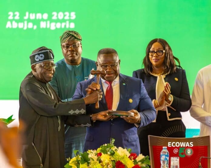 President Bola Ahmed Tinubu of Nigeria hands over to Sierra Leone’s President Julius Maada Bio as ECOWAS chair, June 2025. Photo credit: Facebook/ECOWAS Cedeao.
