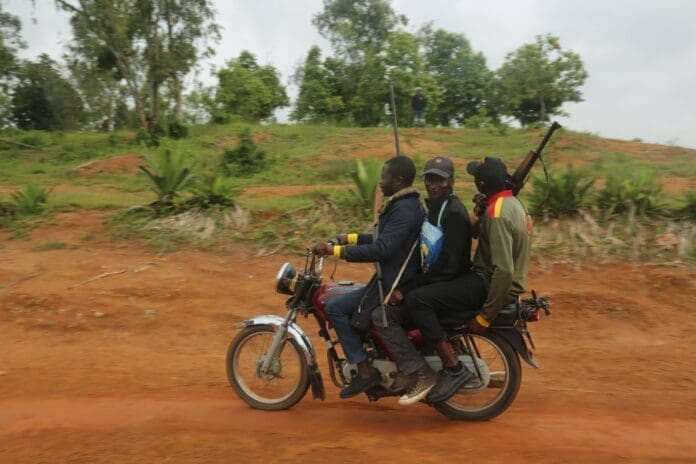 Civilian guards armed with hunting rifles patrol a sparsely forested area in Bokkos, Plateau State. Photo by Masara Kim