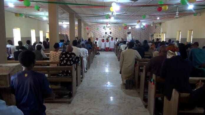 Parishioners at Chapel of Grace - University of Maiduguri Kneeling in Prayers | Photo Credit: M.Kiara