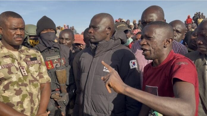 Solomon Dalyop, President of the Berom Youth Movement taunts army officials at the scene of the murder of 12 miners near Jos on December 17.