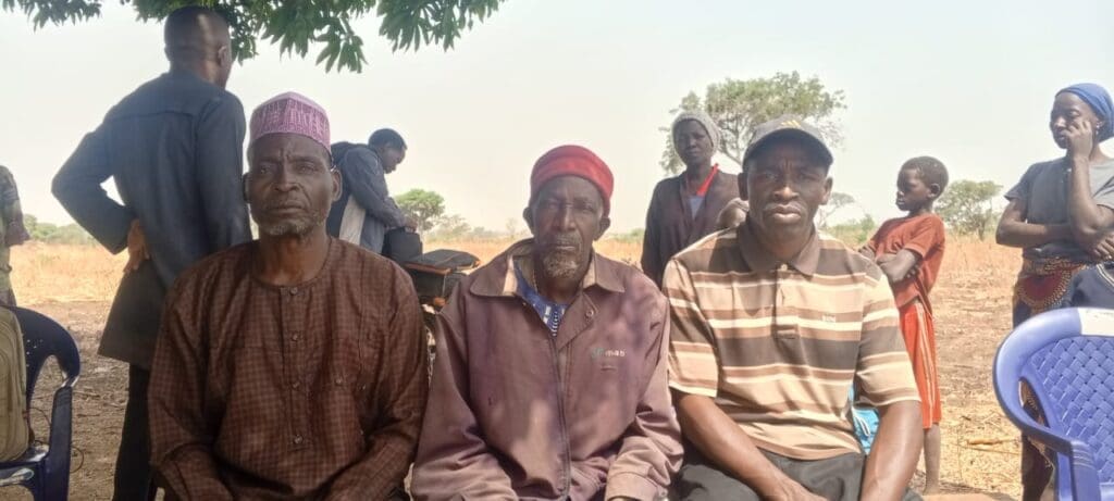 Simone Maisamari, Village Head of Kikwari (in the center with a red cap). Photo by Mike Odeh James.