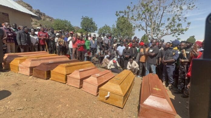 Coffins of nine victims of New Year’s Eve attack near Jos lay in front of heartbroken families prior to mass funeral on January 2nd. Photo by Masara Kim