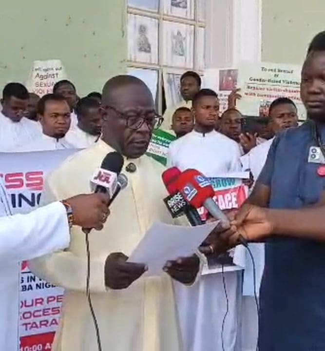 Fr. James Yaro speaking to Press after the protest. Photo by Mike Odeh James. 