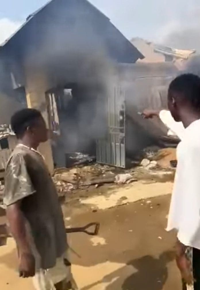 Picture showing residents of Aso 'A' Mararaba, Karu Abuja, standing before a burning house. Picture Courtesy: The Yoruba Times.