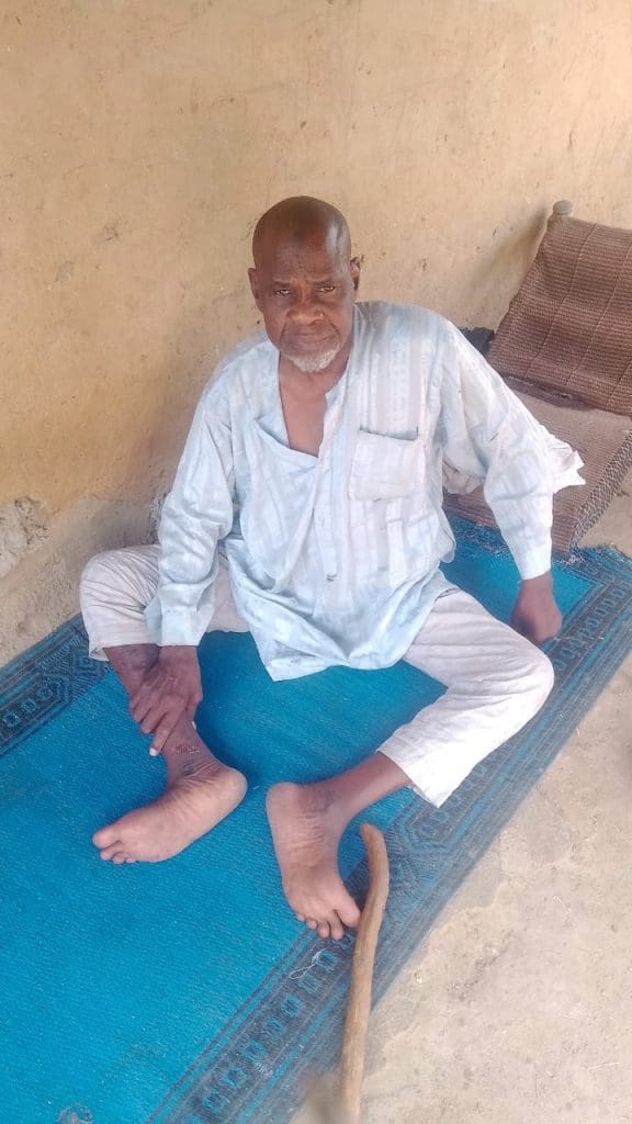 Isa Fali, a man in his sixties who lost the use of his legs following a previous attack on Sabon Gari community was left behind as others fled the region. Photo by Izighe Bitrus Adamu.