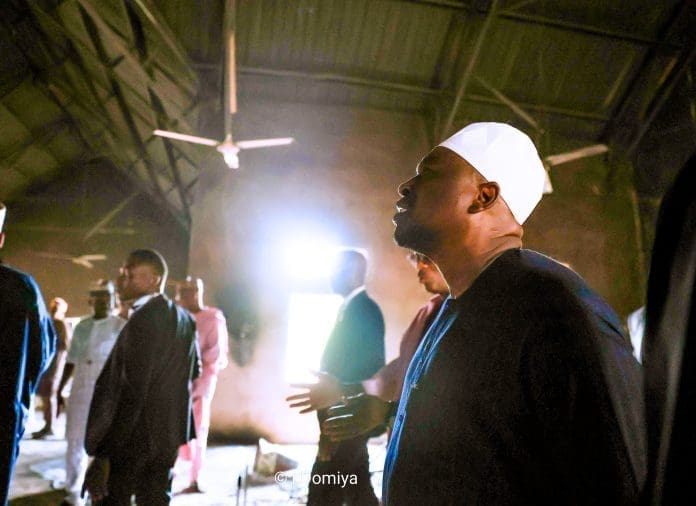 Gov. Ahmadu Umar Fintri in white skull cap and blue long dress inspecting an unnamed Church burnt during the invasion of Guyaku, Gombi County, Adamawa State, North East Nigeria, Monday April 27, 2026. (Credit: @GovernorAUF ).