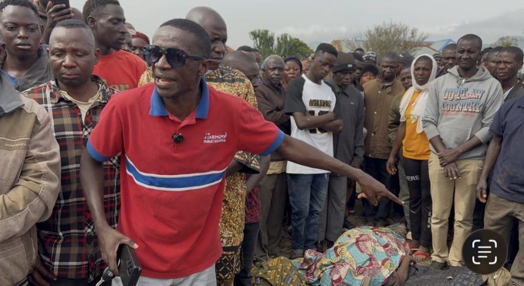 Solomon Dalyop, a tribal youth leader points to the bodies of seven victims of a Monday evening attack while accusing soldiers of complicity with terrorists. Credit Masara Kim/TruthNigeria.