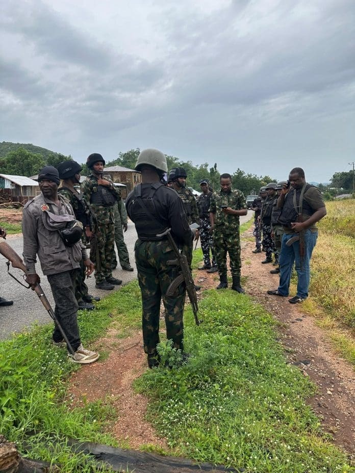Military men and location vigilantes discussing the attack on Universal Basic Education - UBE school in Iluke Bunu, Kogi state. Picture Courtesy: Nigerian Army.